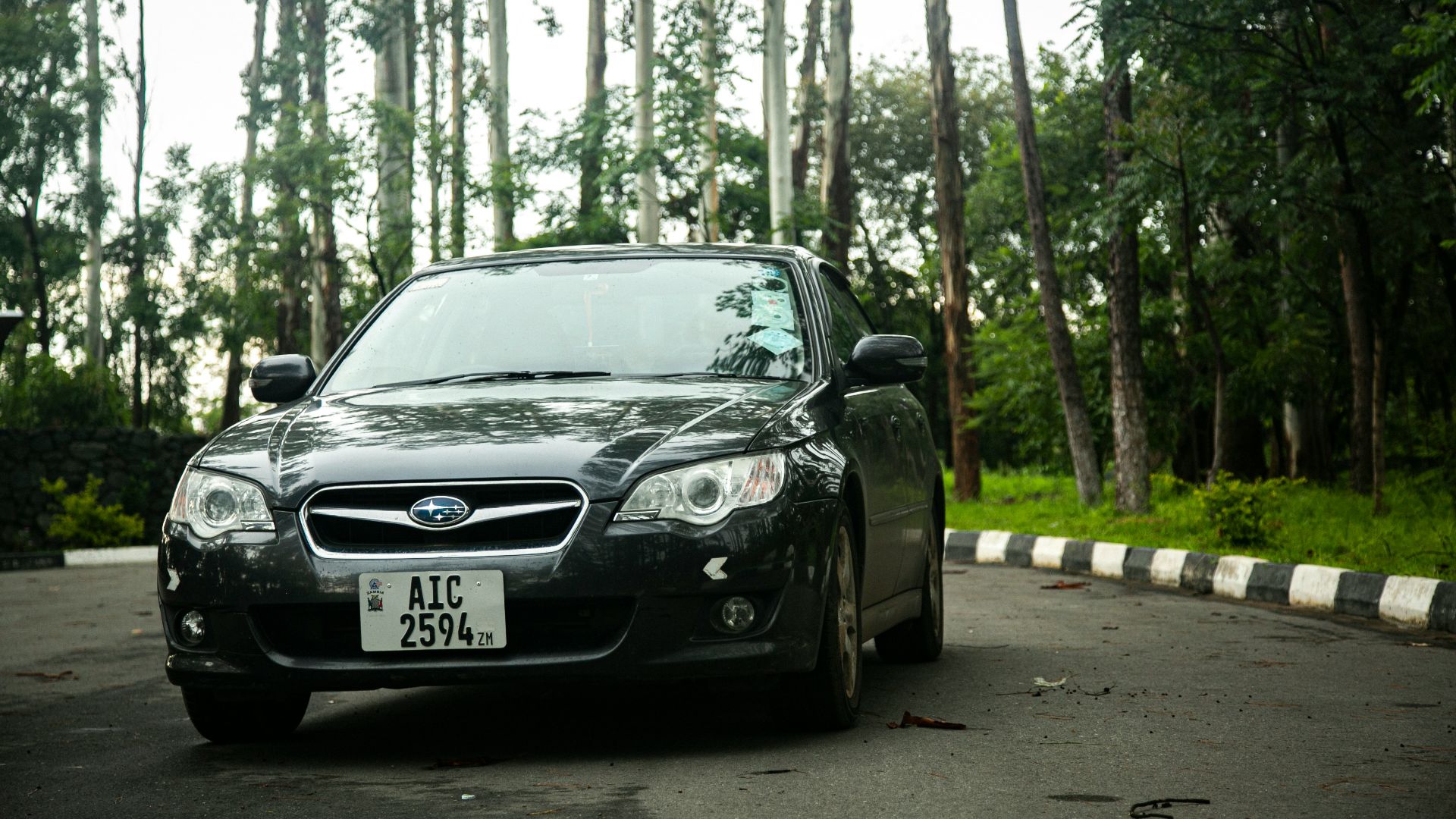 a black car parked on the side of the road