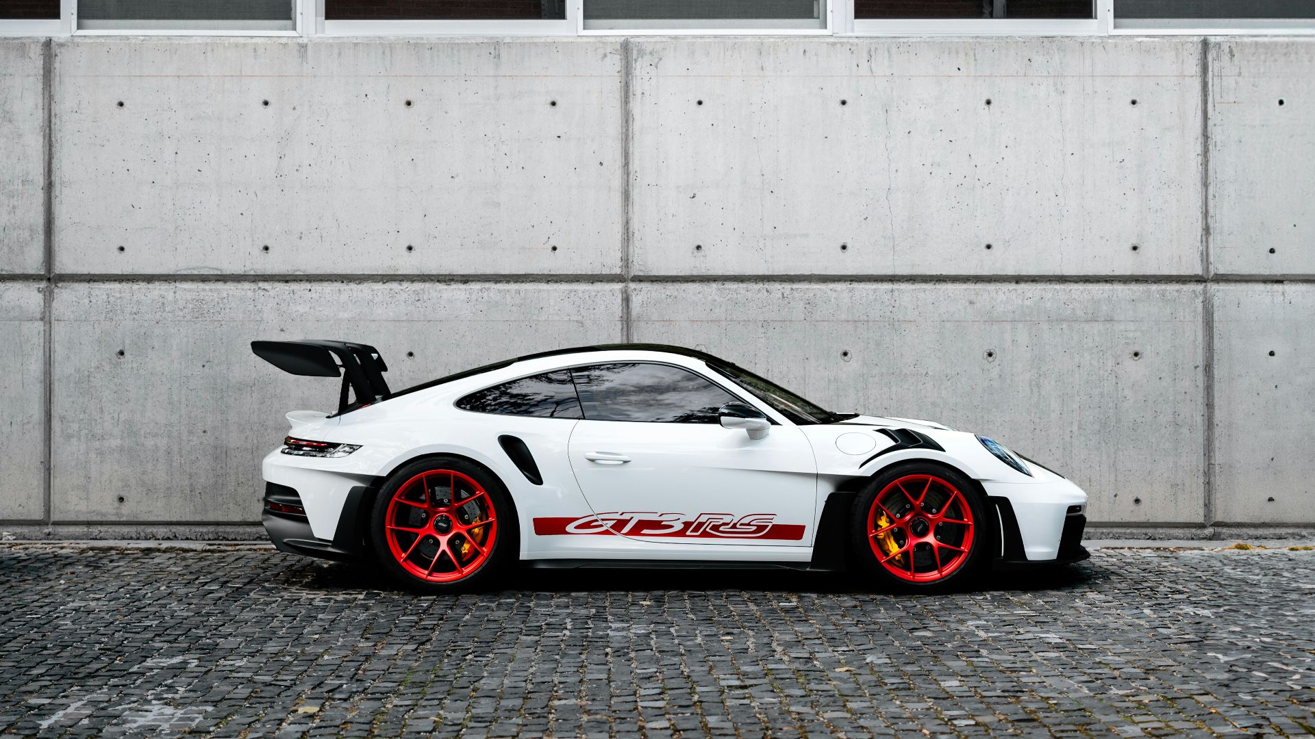 a white sports car parked in front of a building