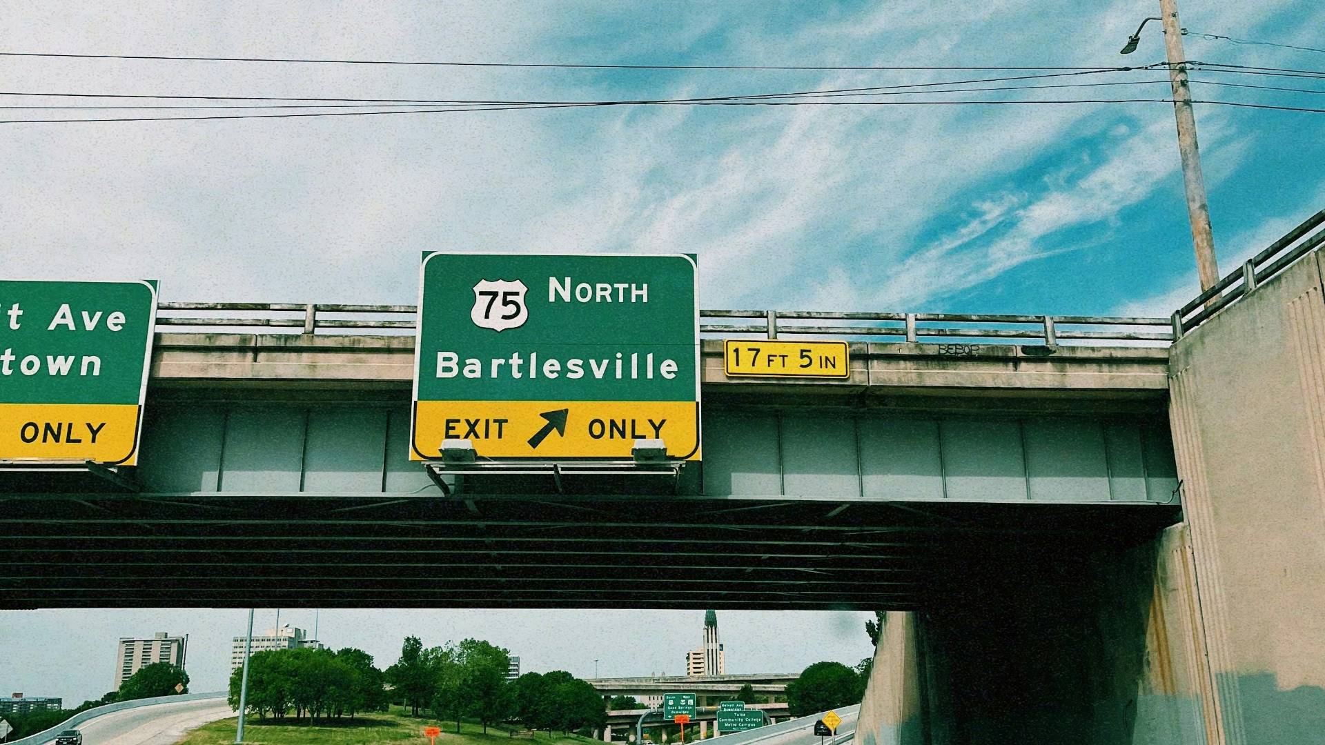 a highway with two freeway signs above it