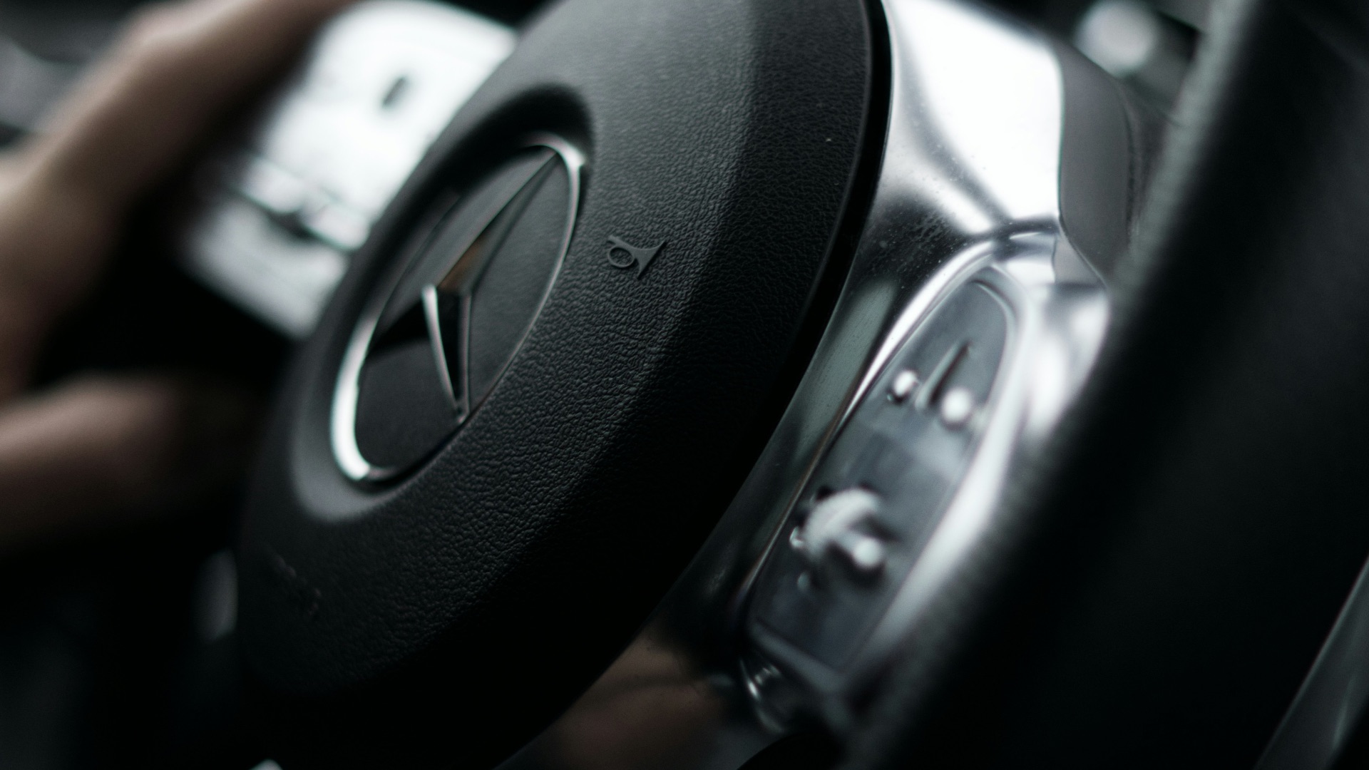 a person driving a car with a steering wheel