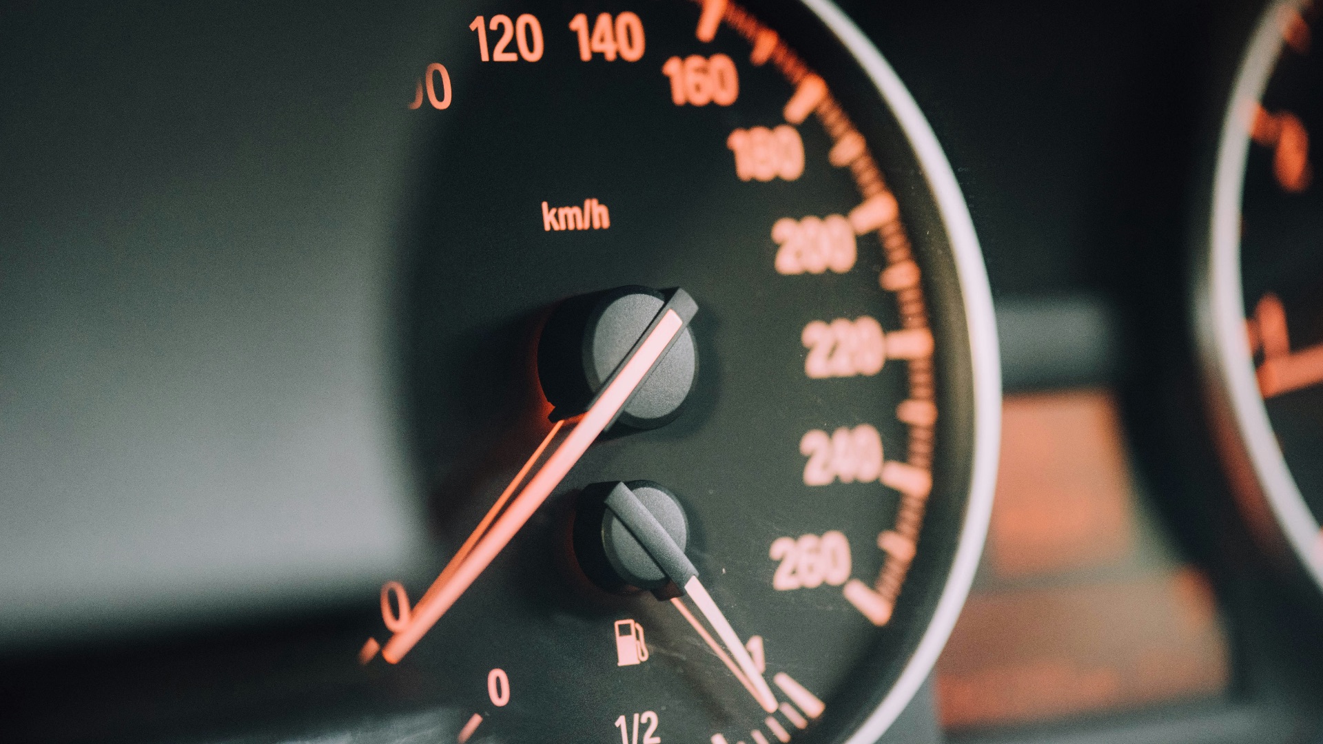 closeup photo of black analog speedometer