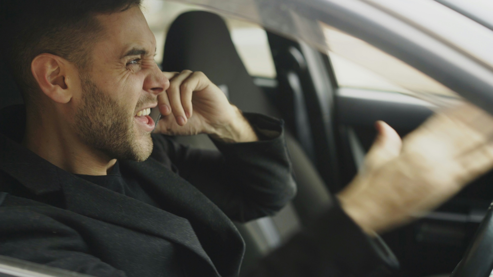Man talking on phone while driving a car