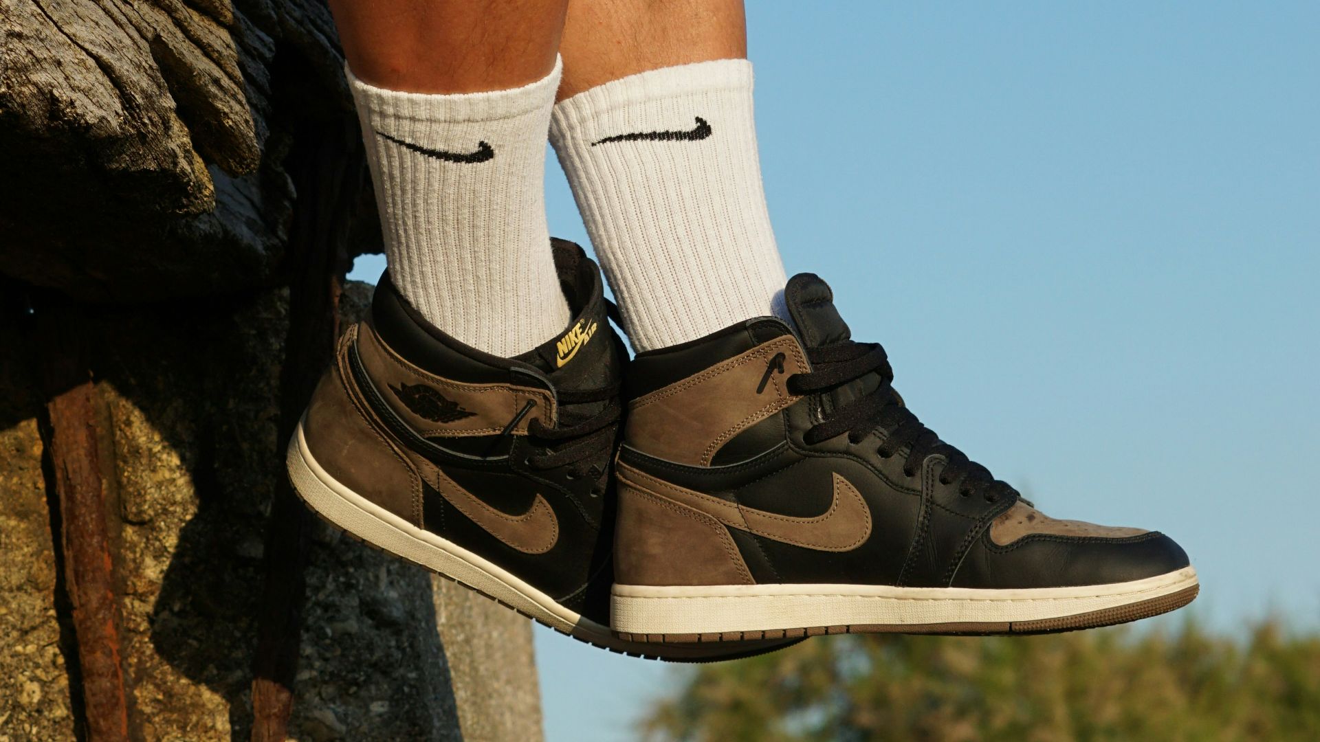 Man wearing brown and black high-top sneakers