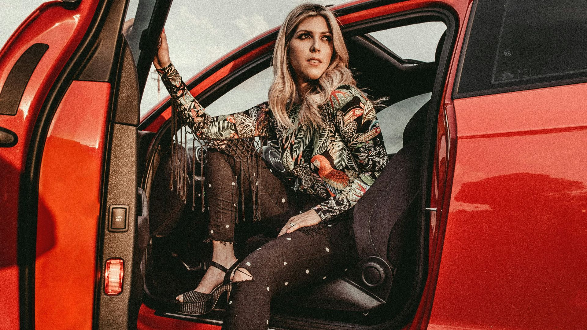 woman in black pants sitting on driver's seat