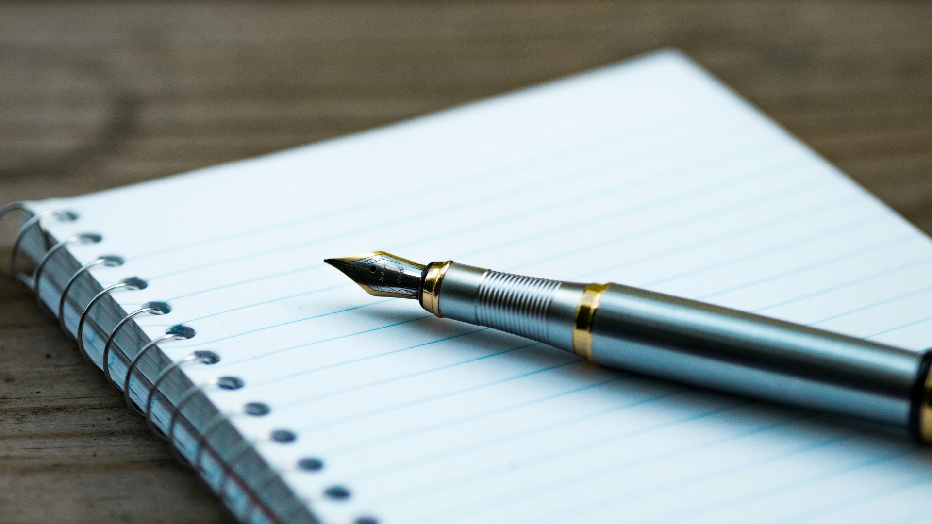 fountain pen on spiral book