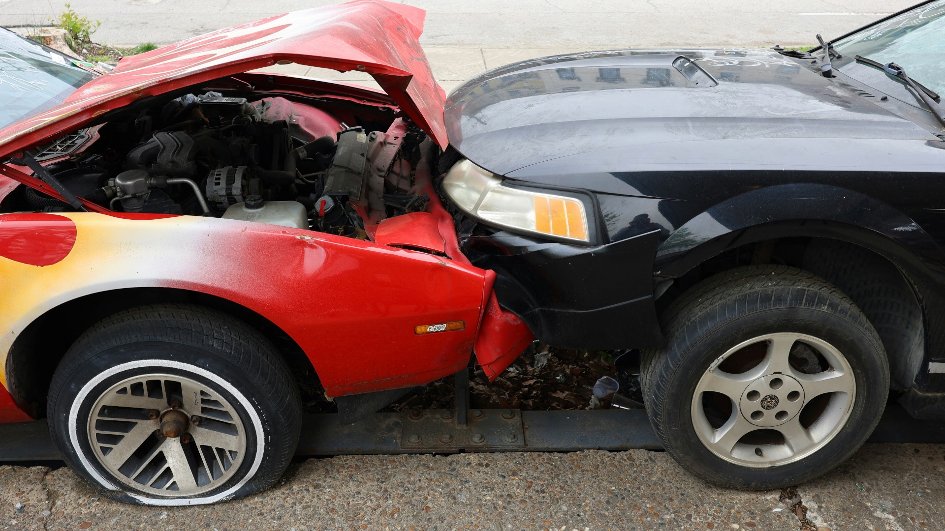Cars are involved in a frontal collision.