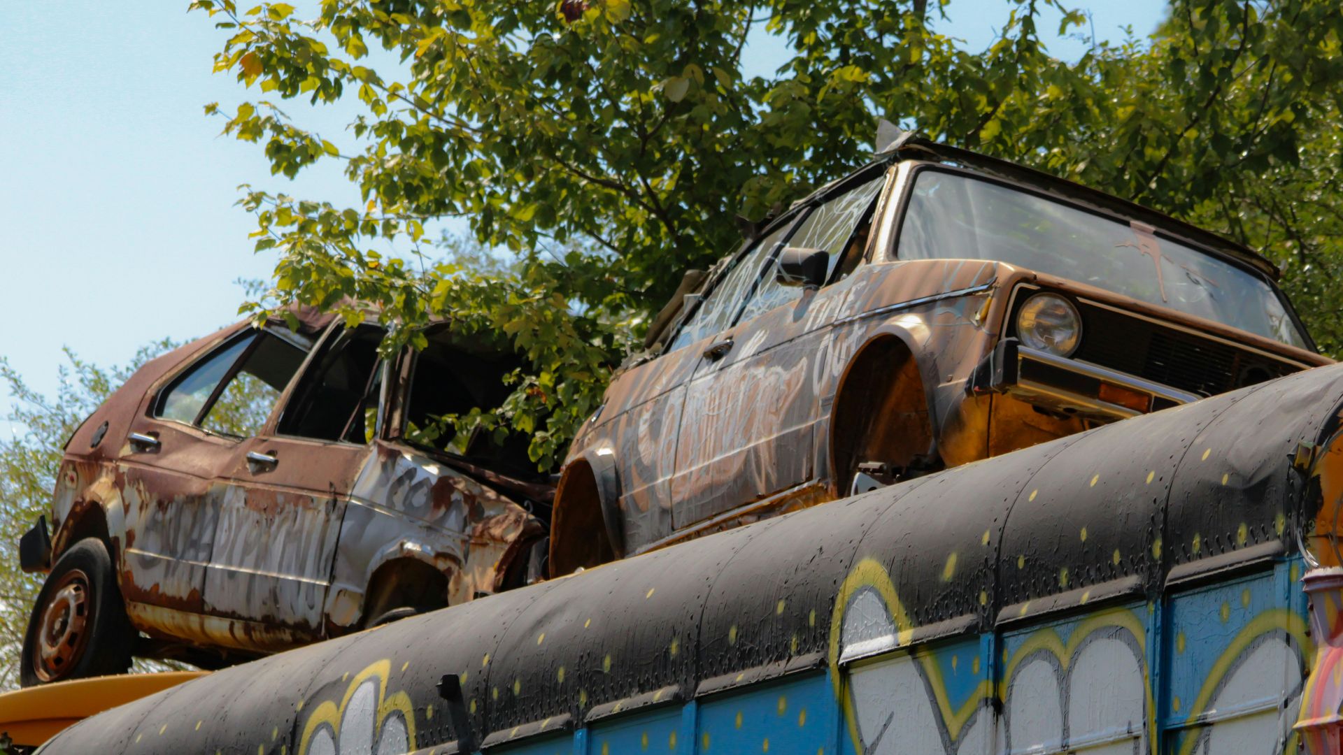 A couple of cars that are on top of a bus