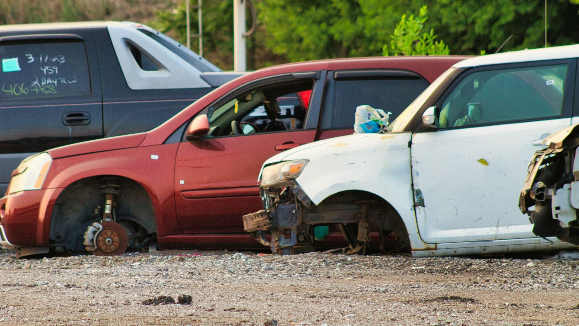 a couple of cars that are sitting in the dirt