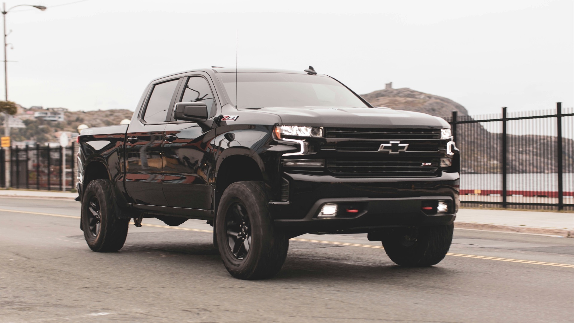 black chevrolet single cab pickup truck on gray sand during daytime