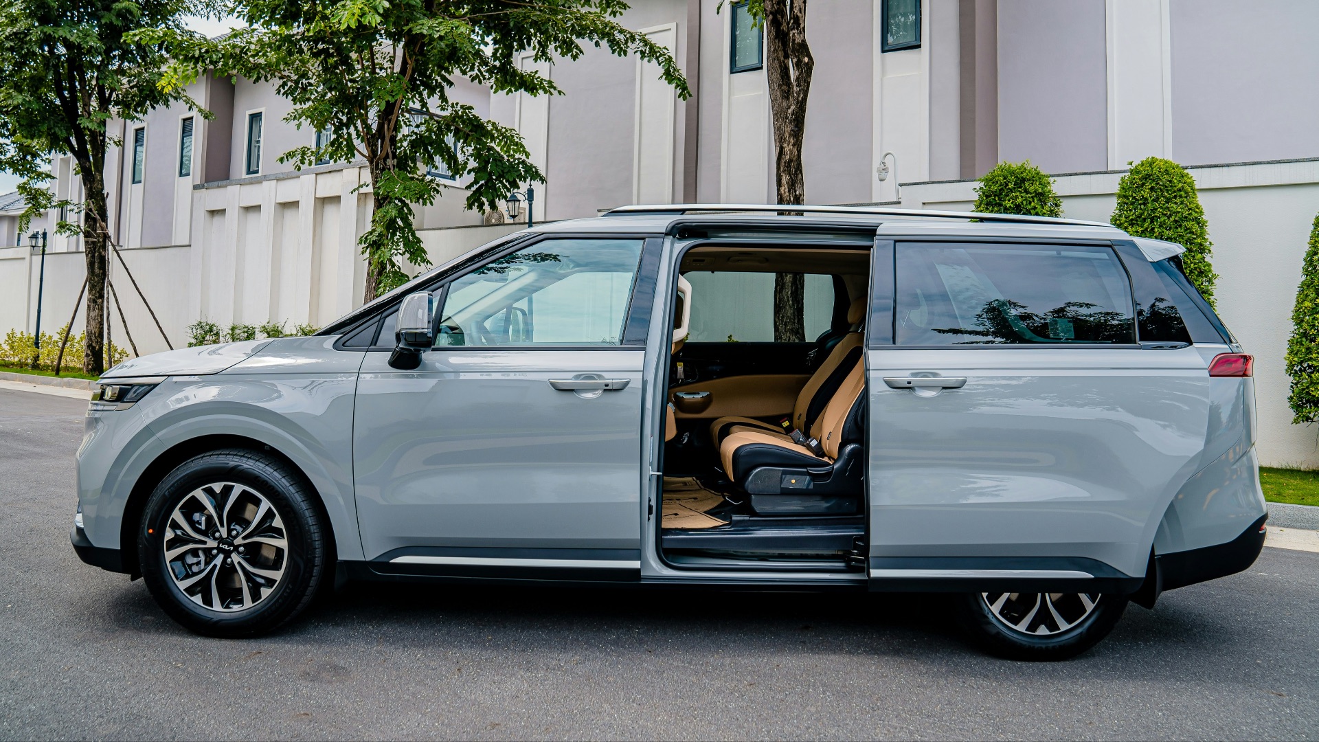 a silver minivan parked on the side of the road