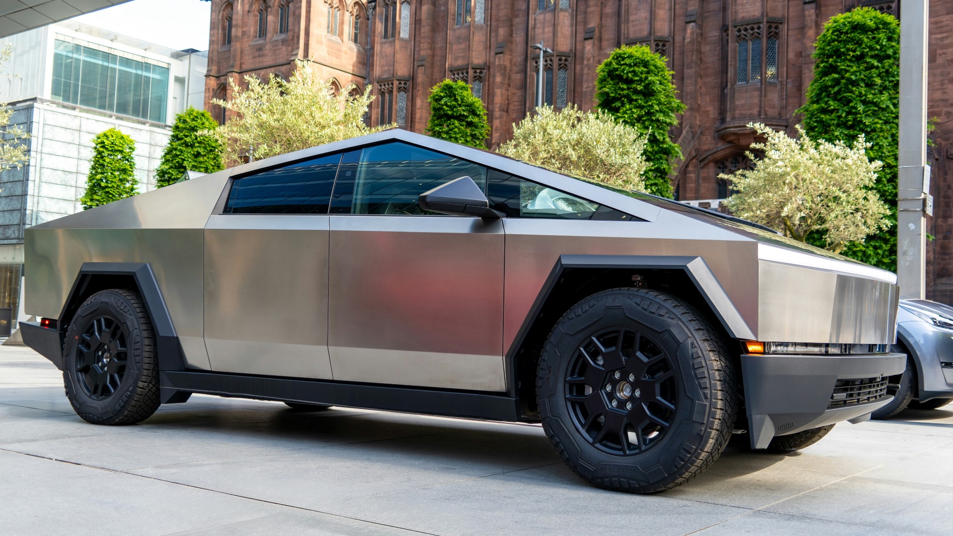 a futuristic car parked in front of a building