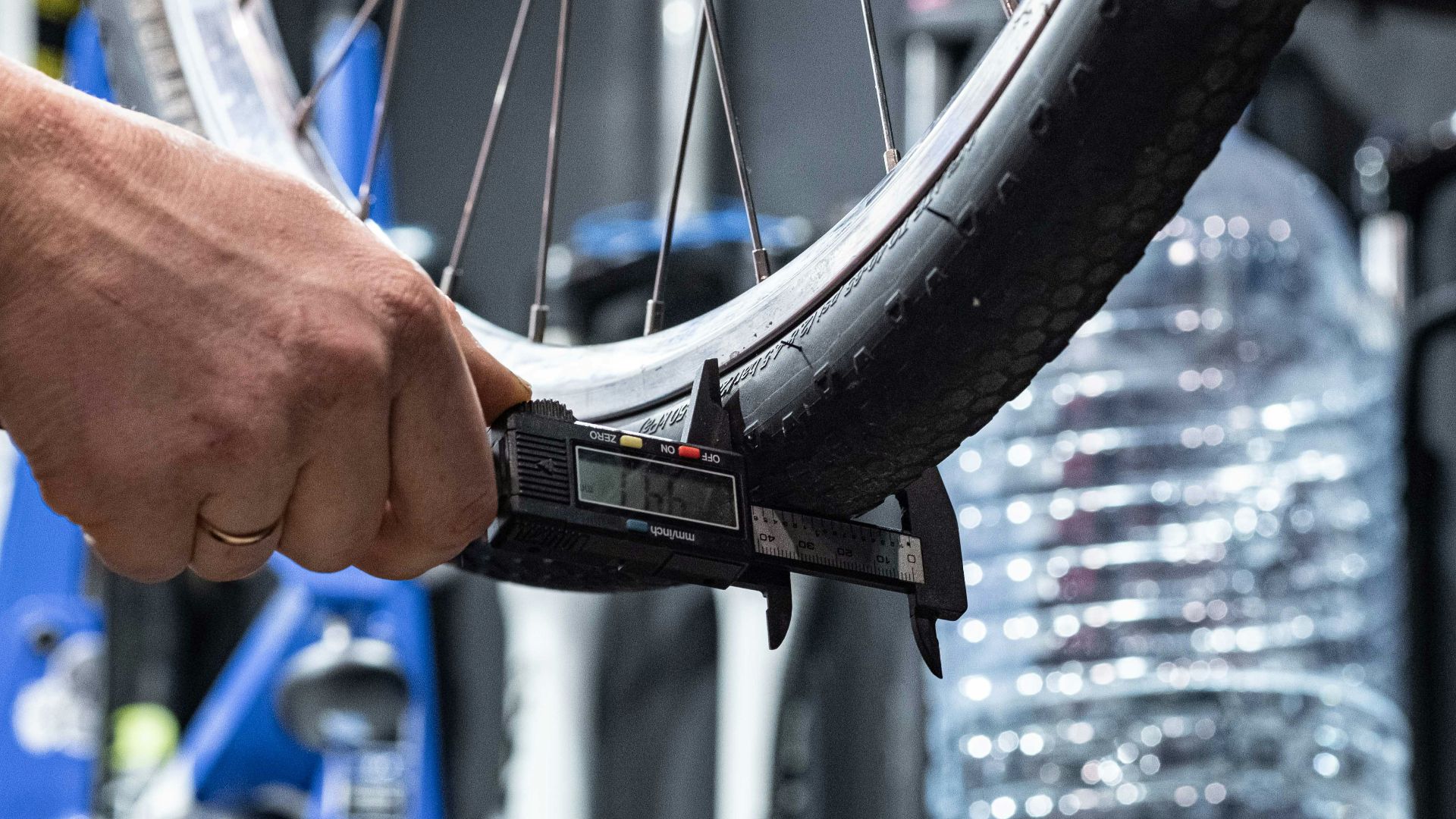 a person holding a bike tire in their hand