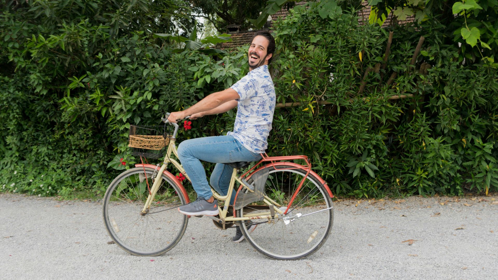 A man riding a bike down a street