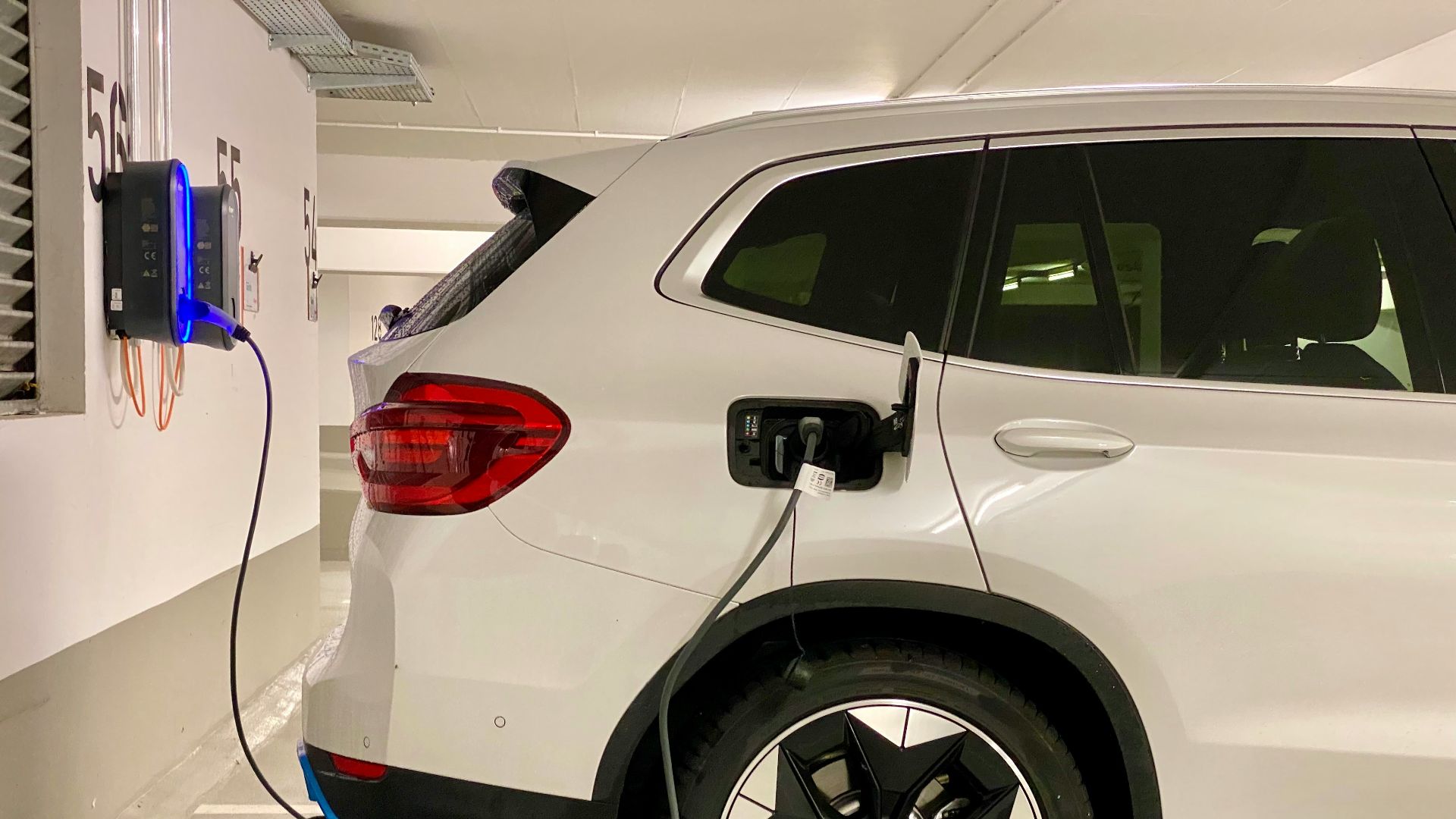 an electric car plugged in to a charging station