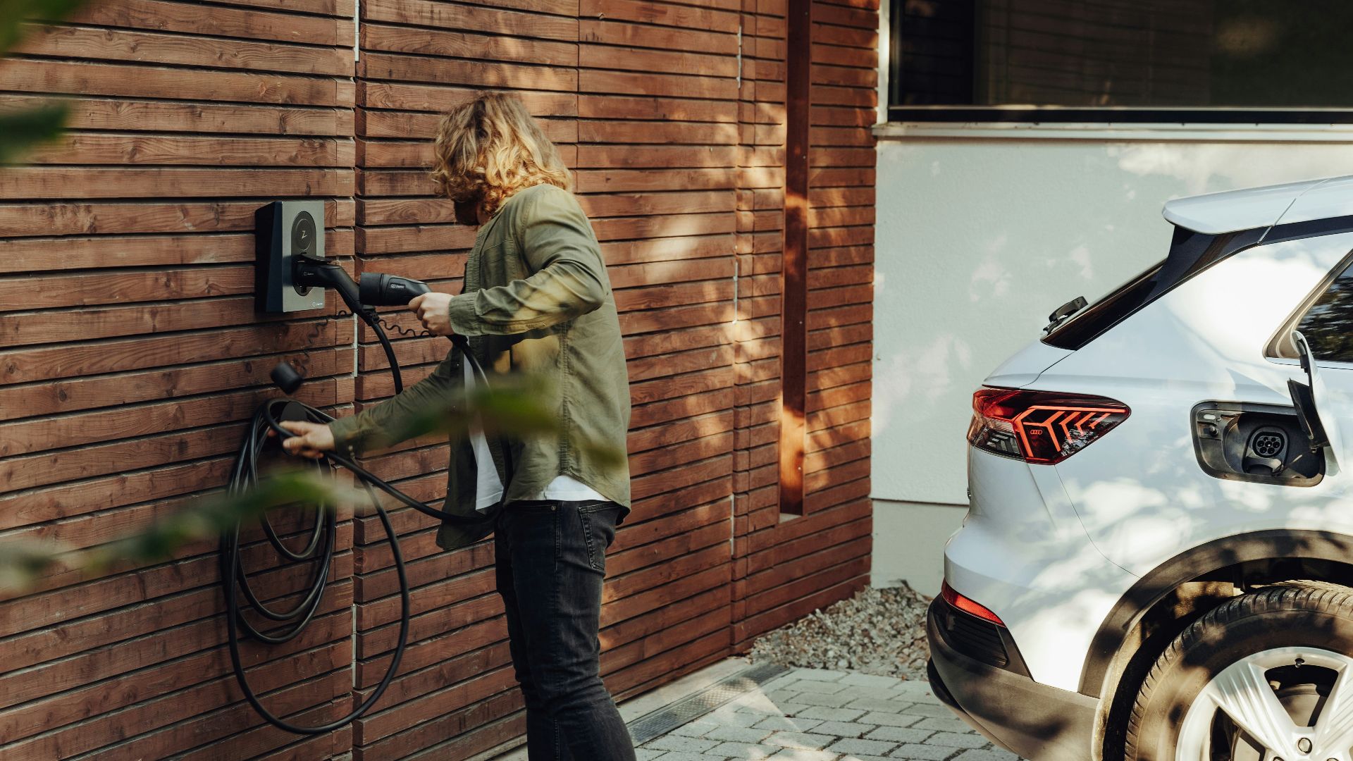 a woman is using a power washer on a brick wall