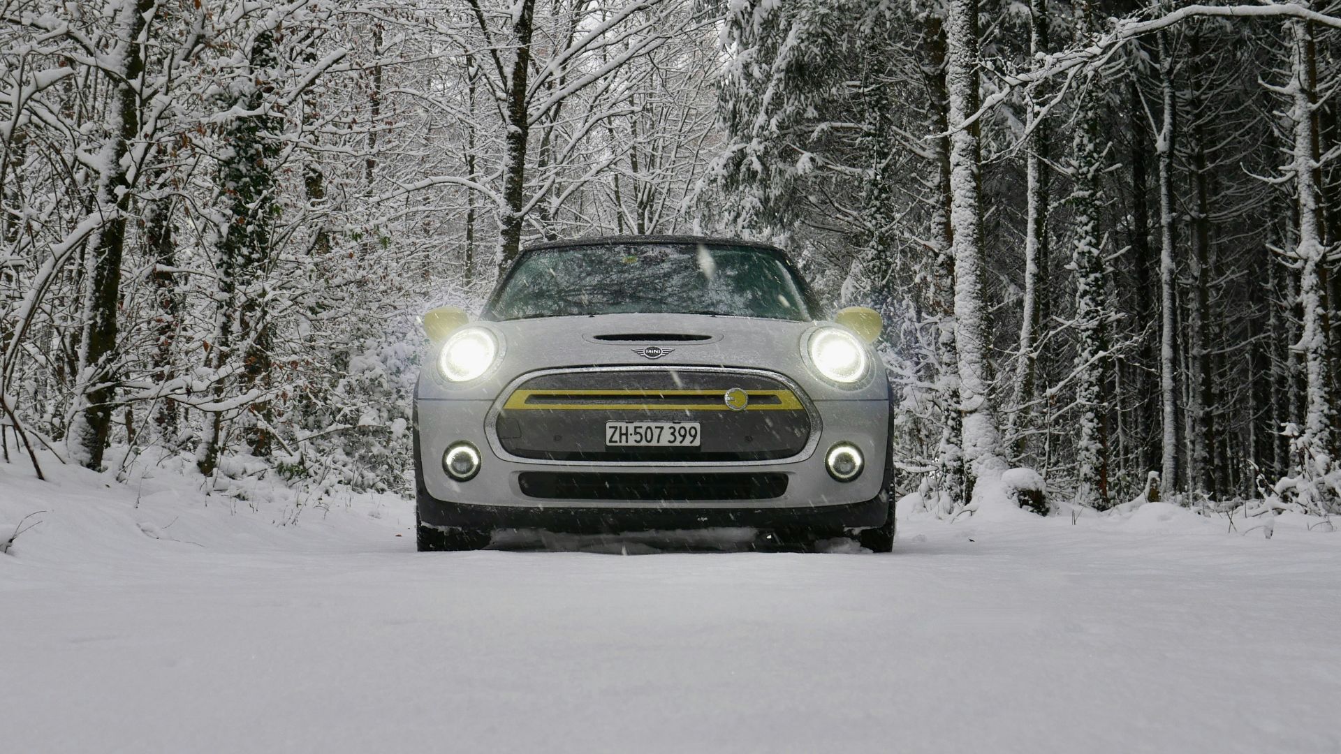 a car driving down a snow covered road