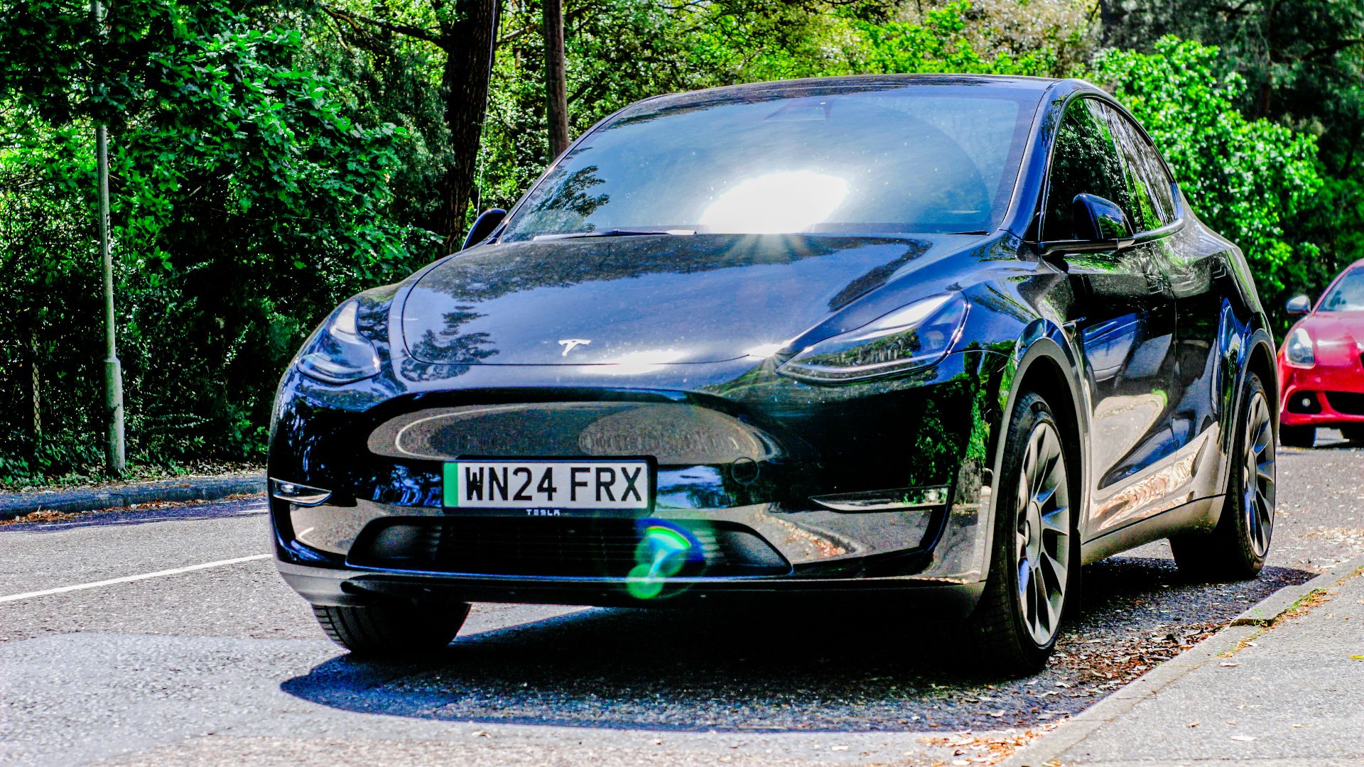 Two cars are parked on the side of the road