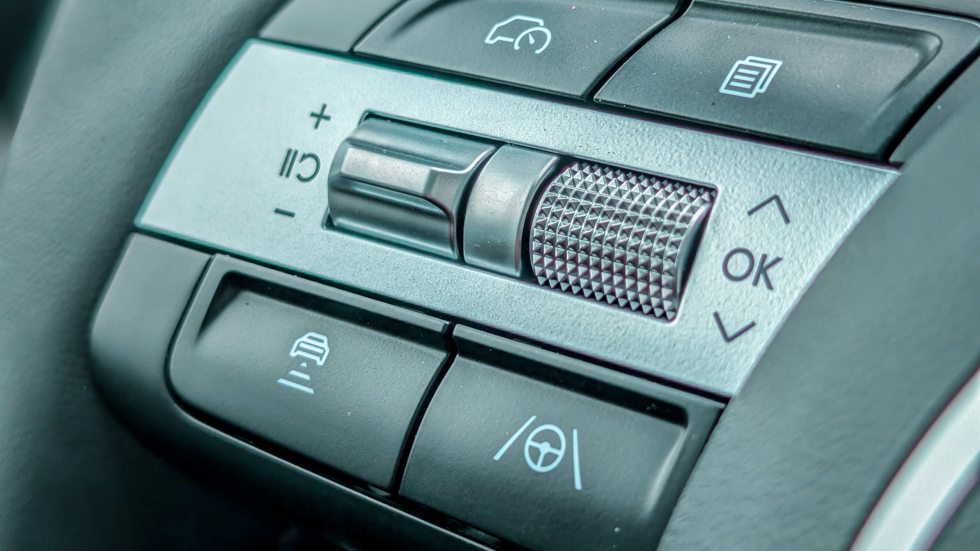 Close-up of a modern car steering wheel controls.