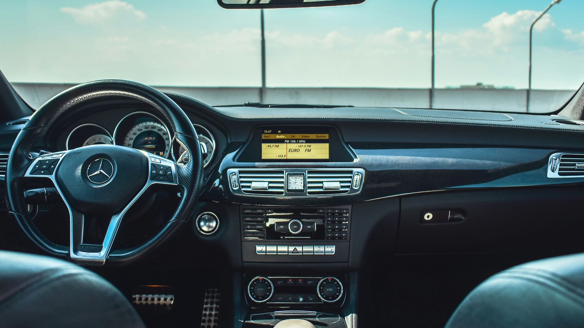 black Mercedes-Benz vehicle steering wheel