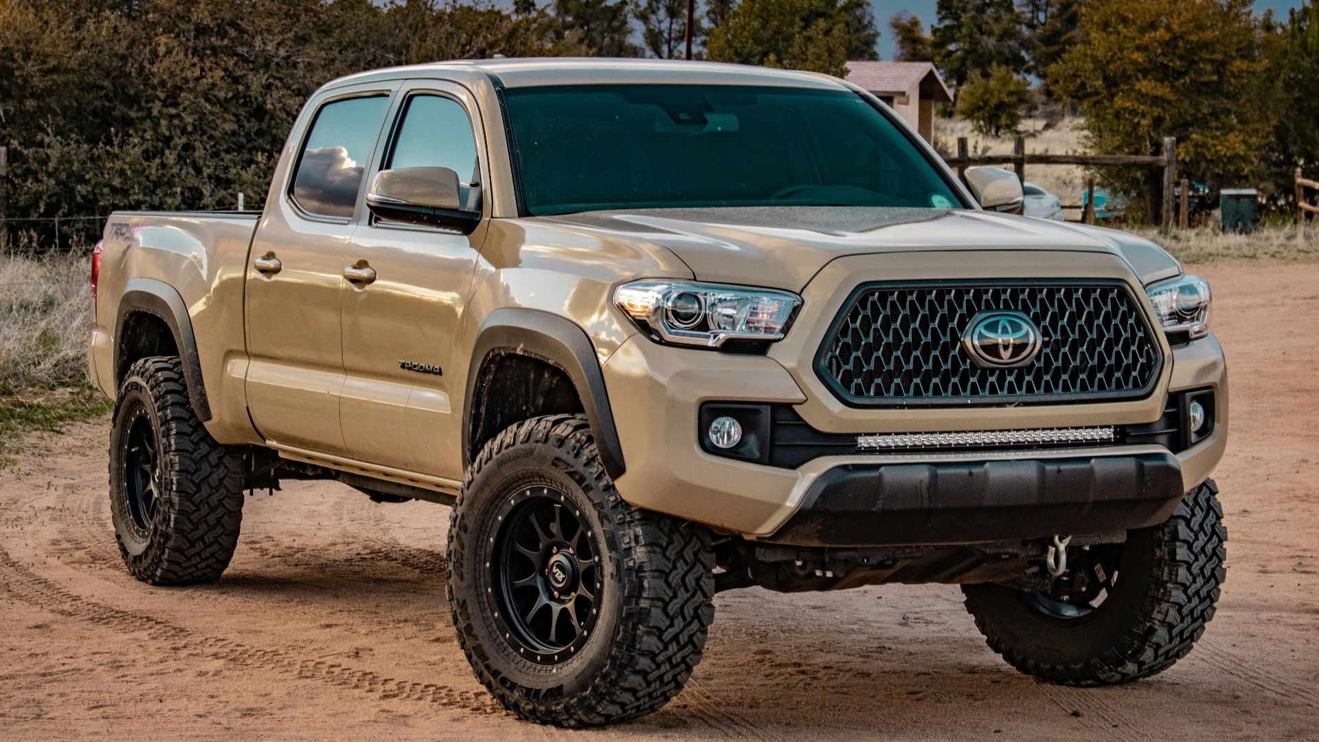 white Toyota crew cab pickup truck on ground