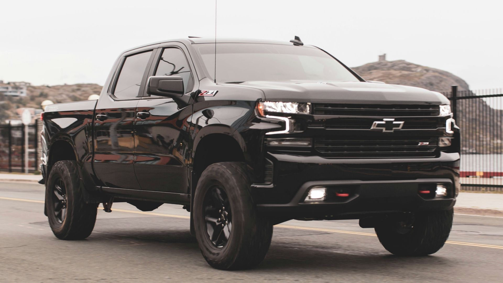 black chevrolet single cab pickup truck on gray sand during daytime