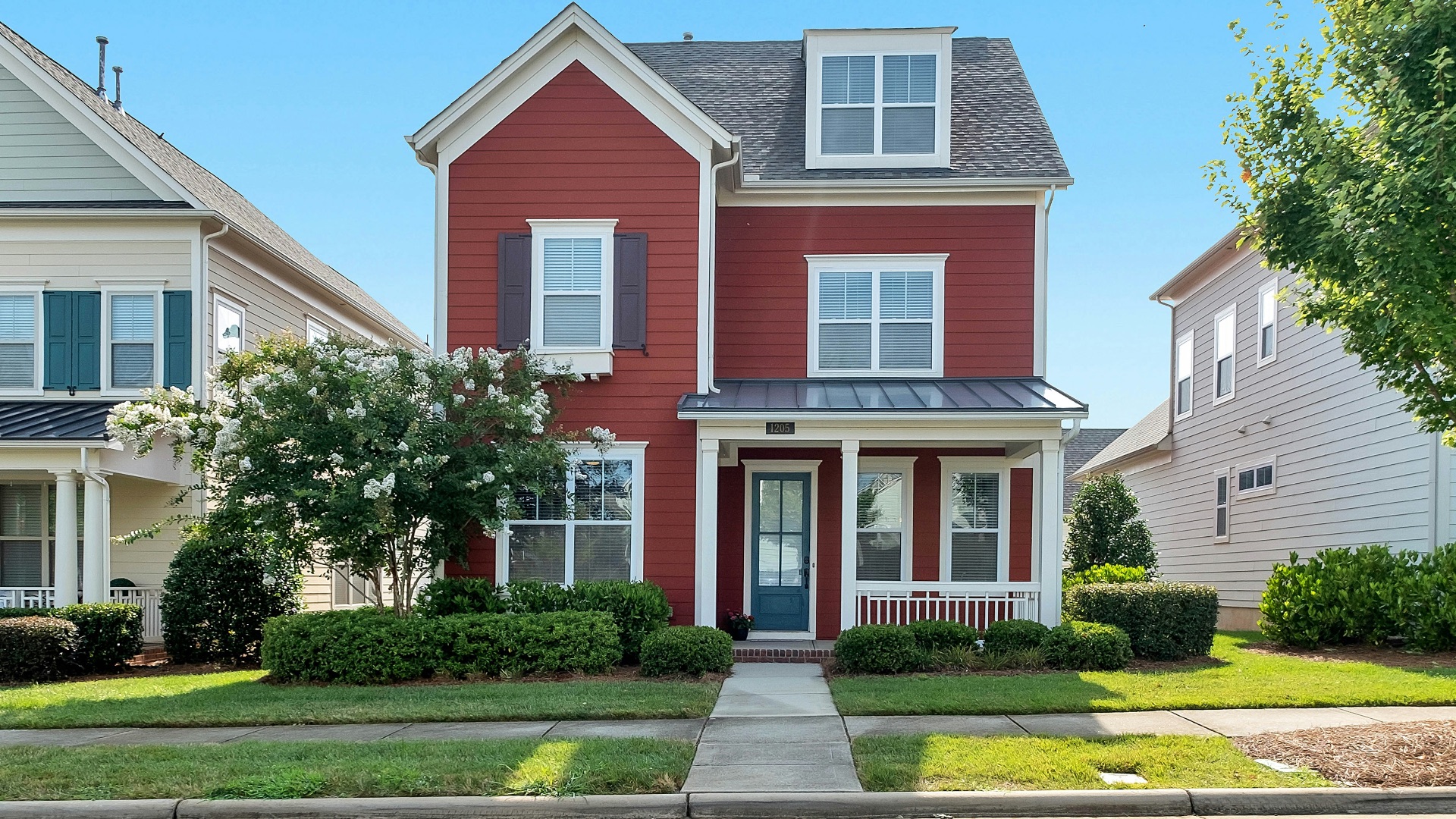 white and brown concrete house near green trees during daytime
