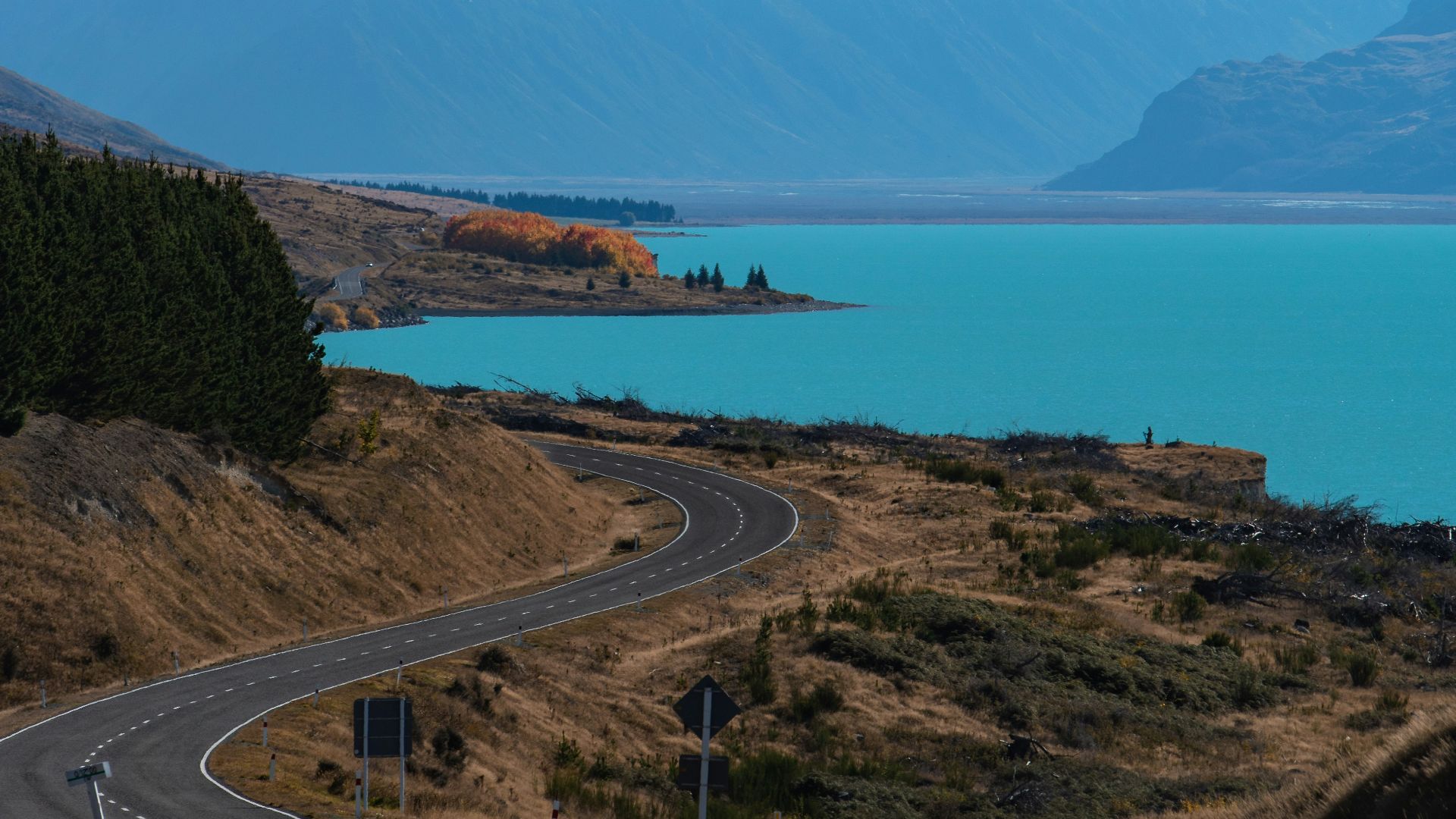 snow covered mountain near body of water during daytime