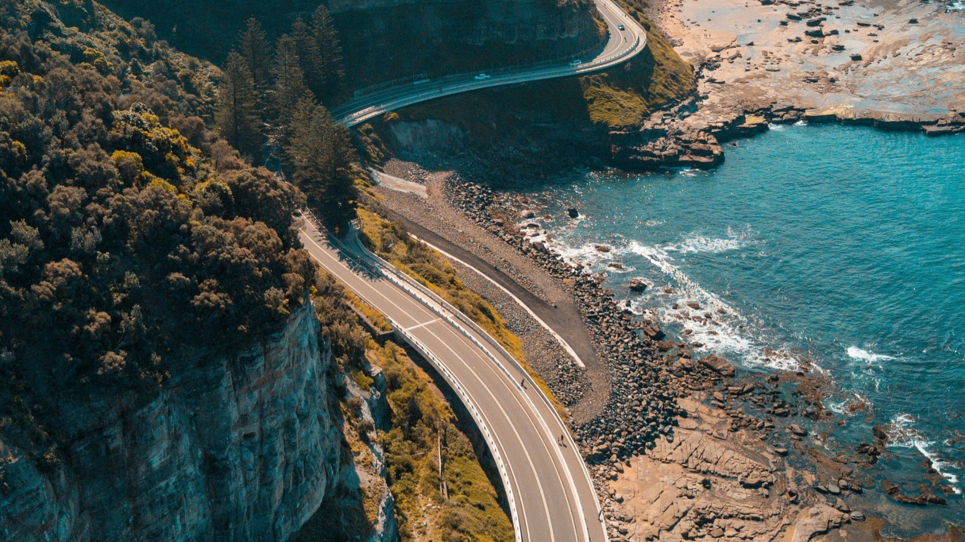 birds eye view of highway beside bay