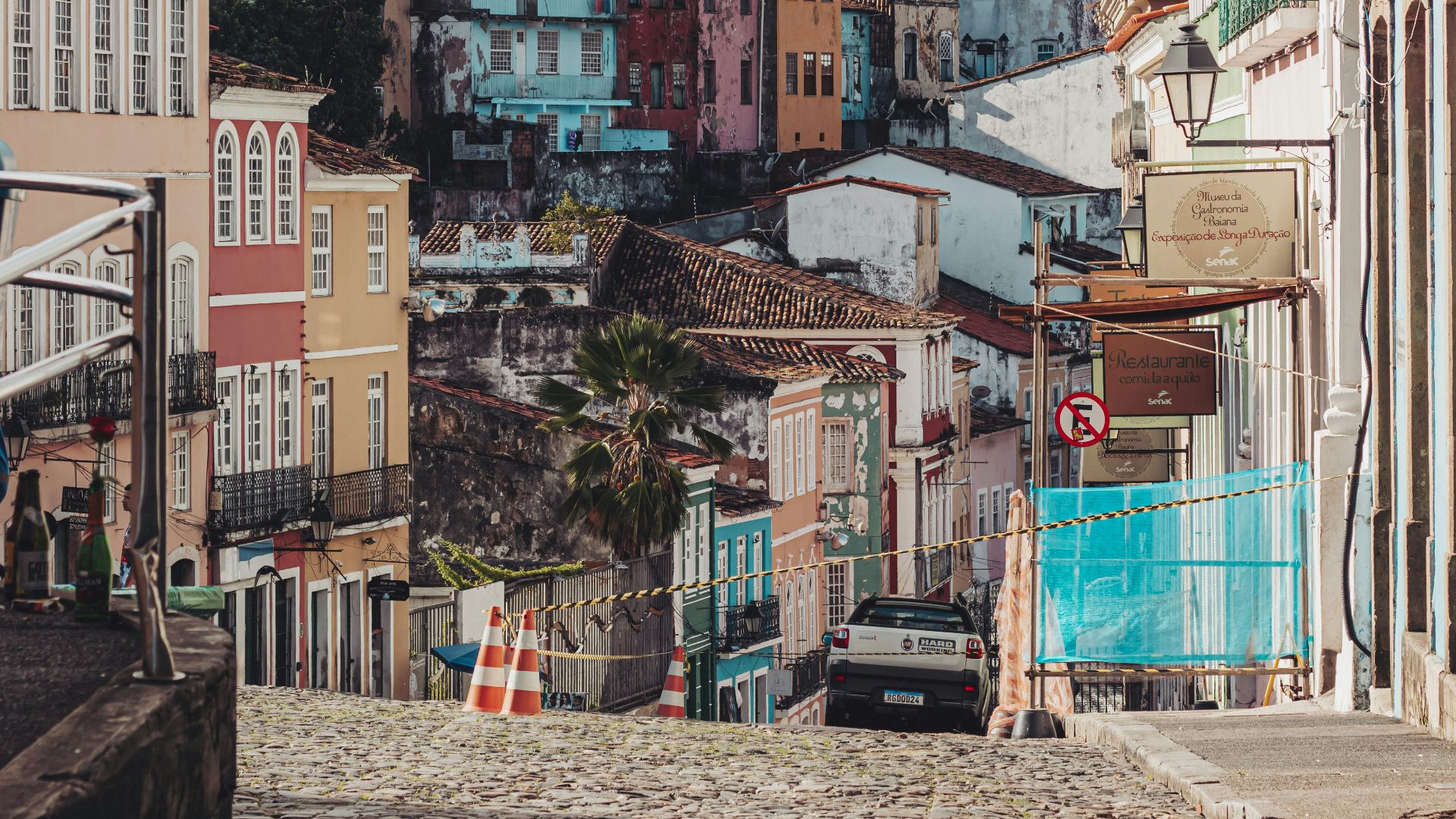 brown and white concrete buildings under white clouds during daytime