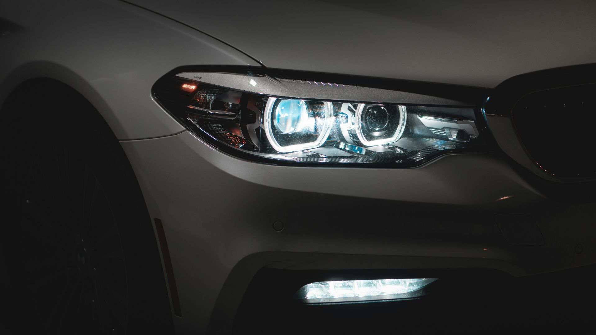 gray car with white and blue lights