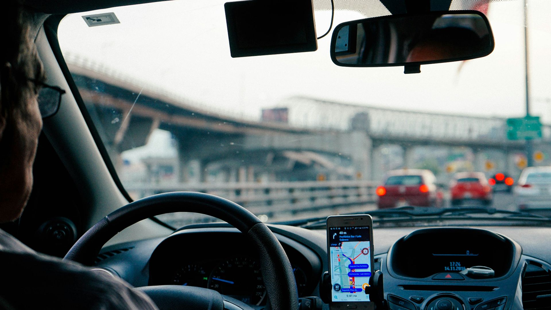 man driving vehicle with GPS system turned on