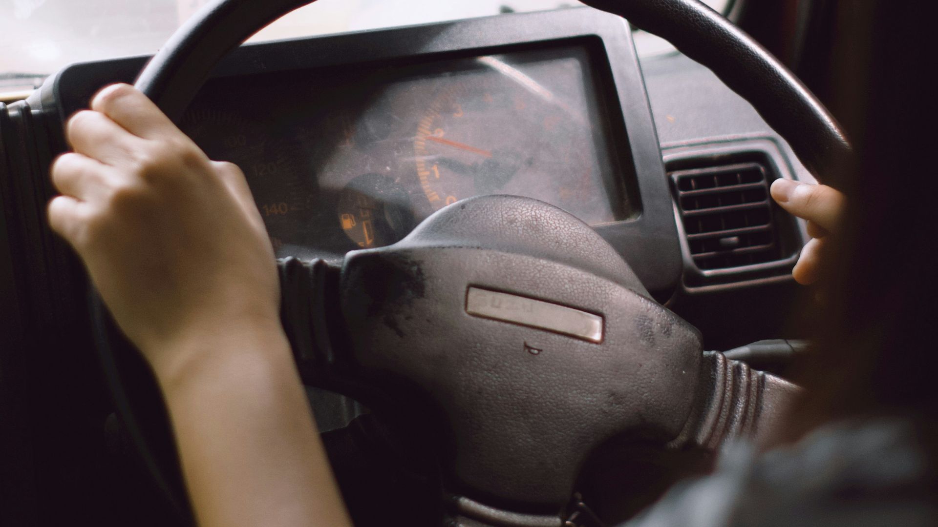 person driving car during daytime