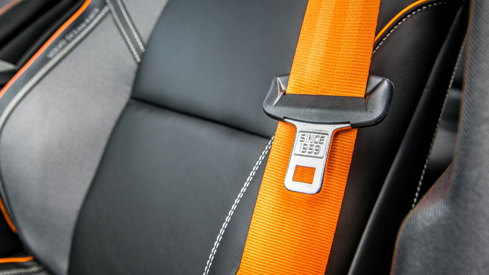 orange and white belt on black leather seat