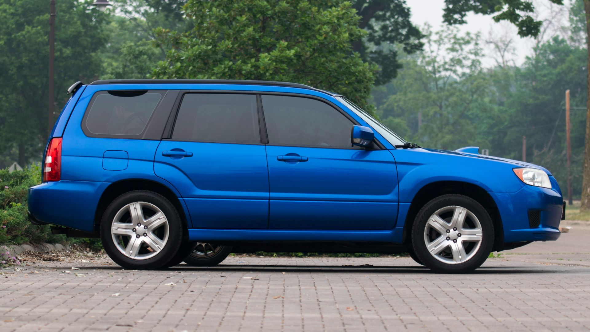 a blue suv parked on the side of the road