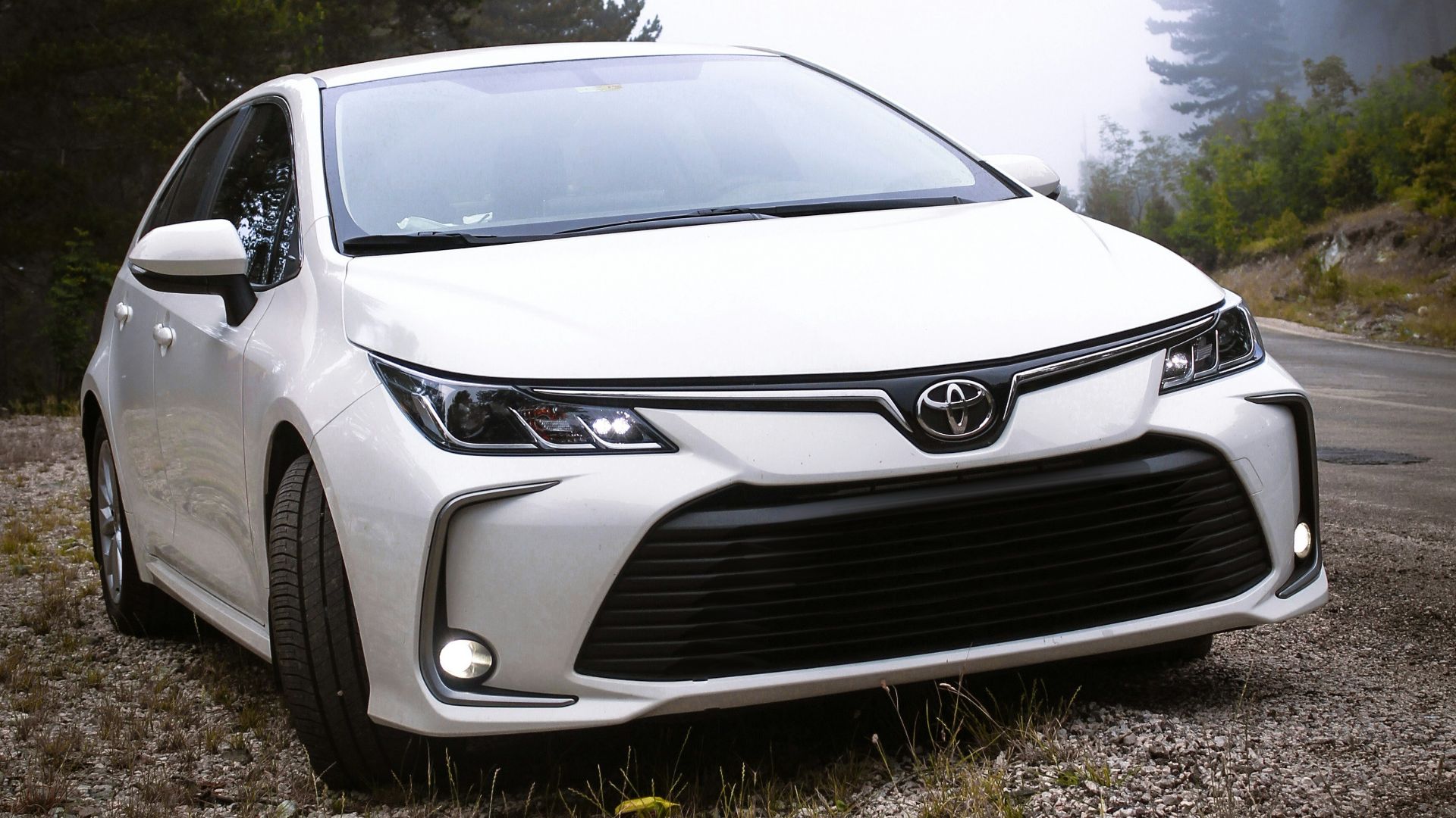 a white car parked on the side of a road