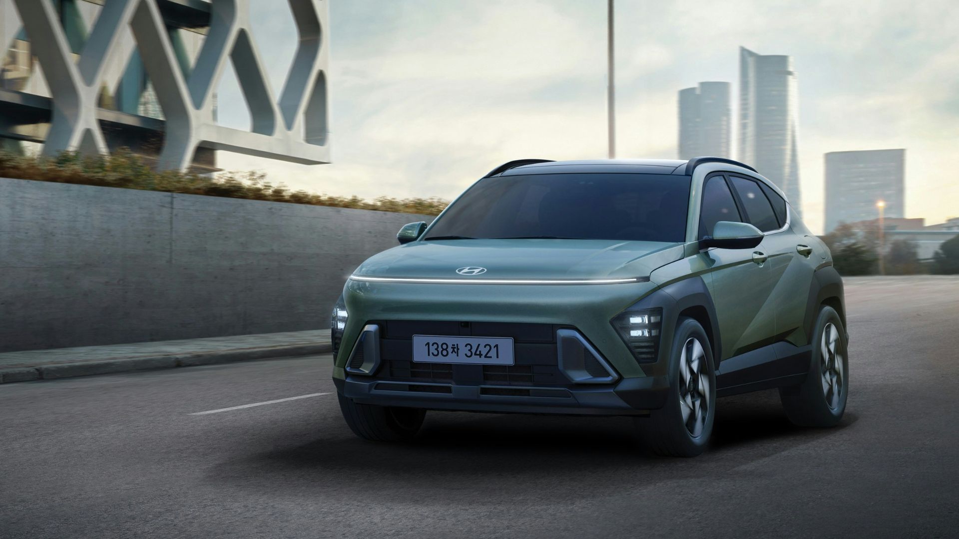 a green suv driving down a city street