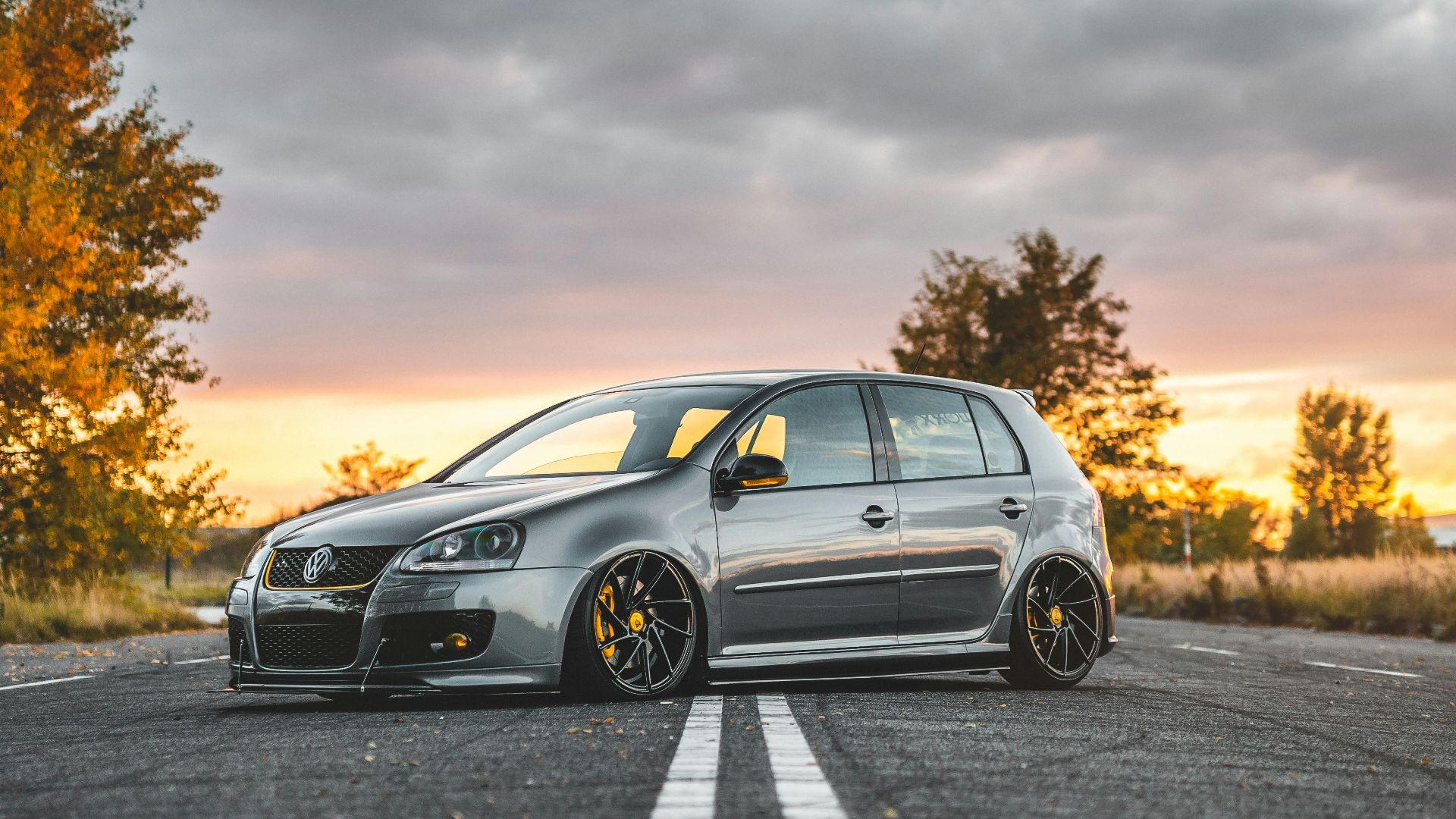 silver 5-door hatchback parked in the middle of the road during day