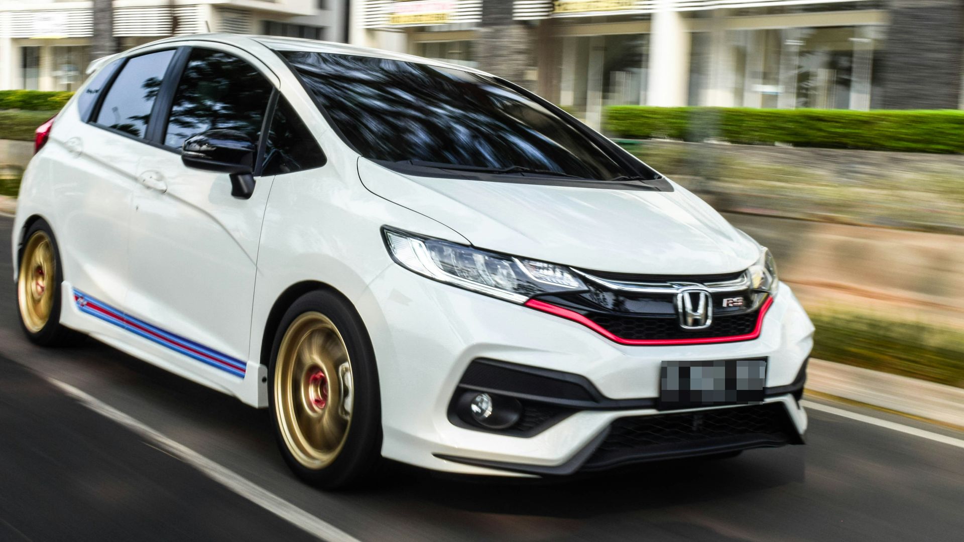 white honda sedan on road during daytime