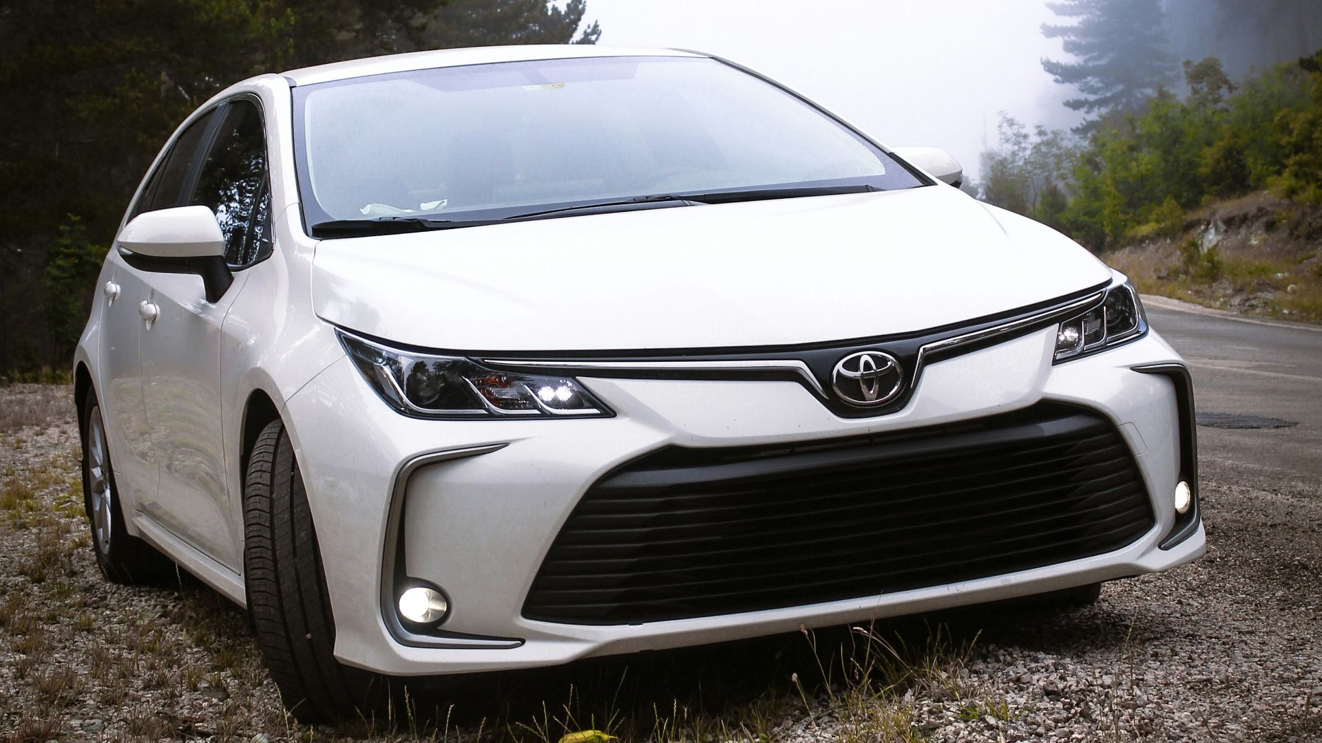 a white car parked on the side of a road