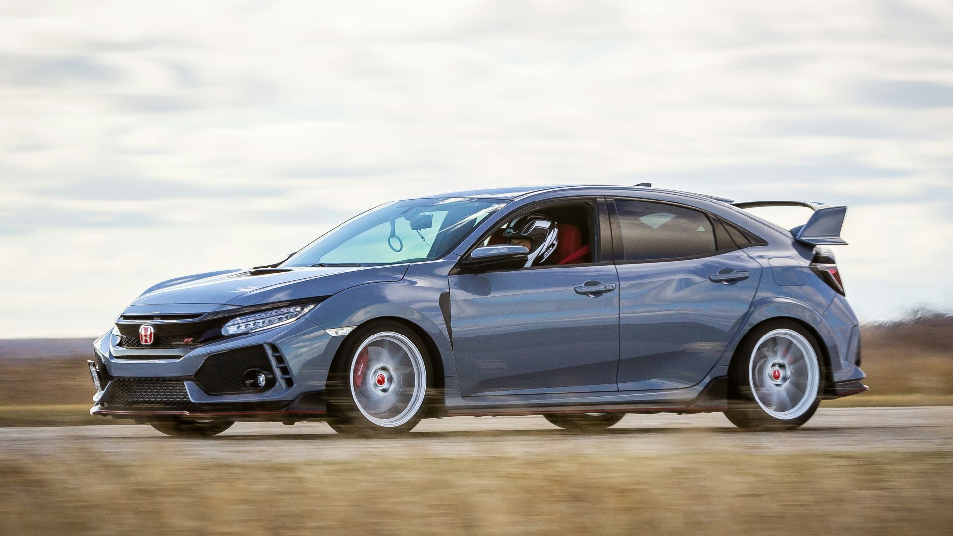 blue porsche 911 on brown field