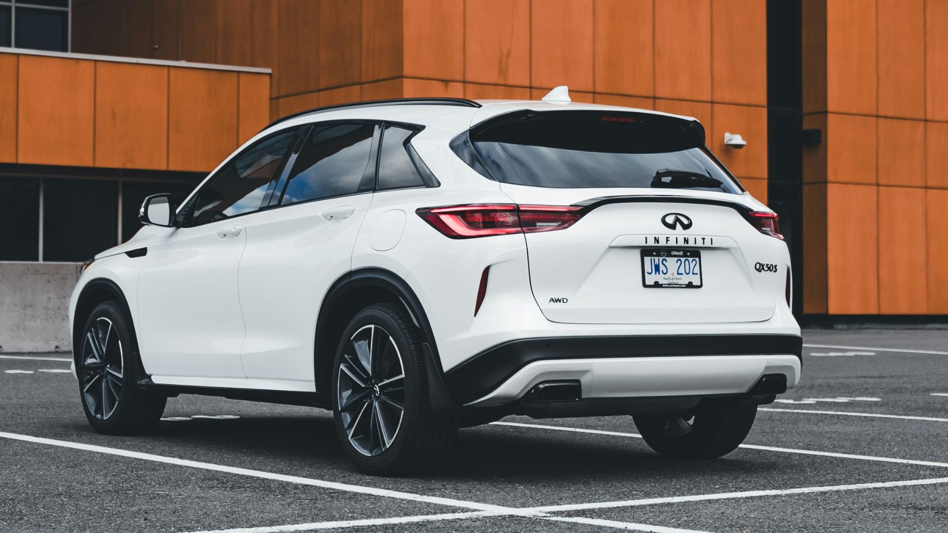 White suv parked in front of orange building