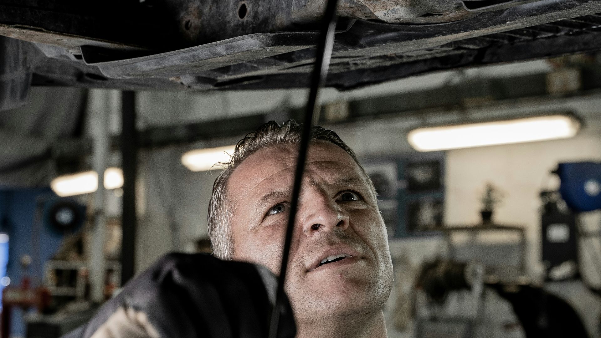 a man working on a car in a garage