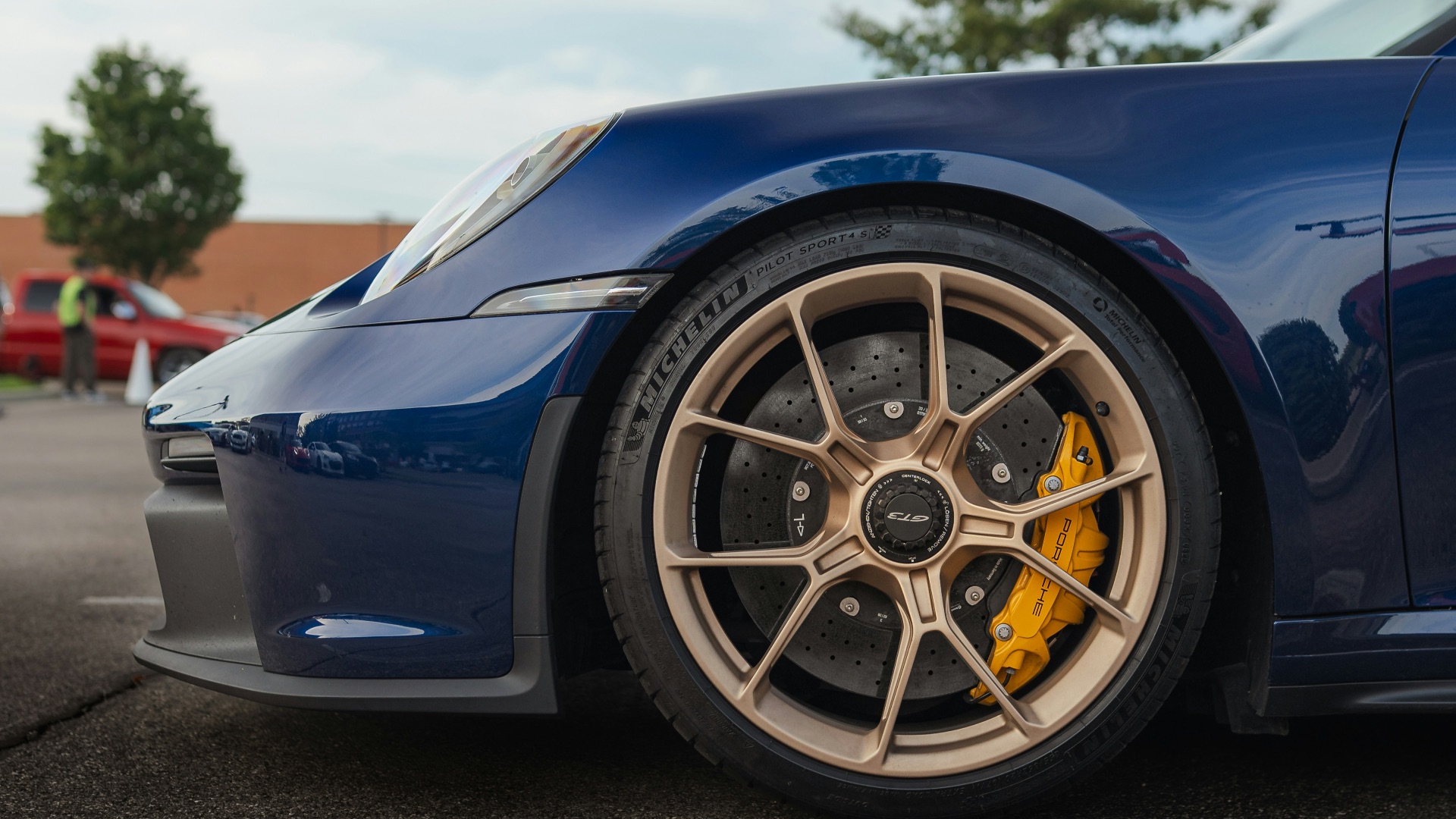 Close-up of a blue sports car wheel and fender.