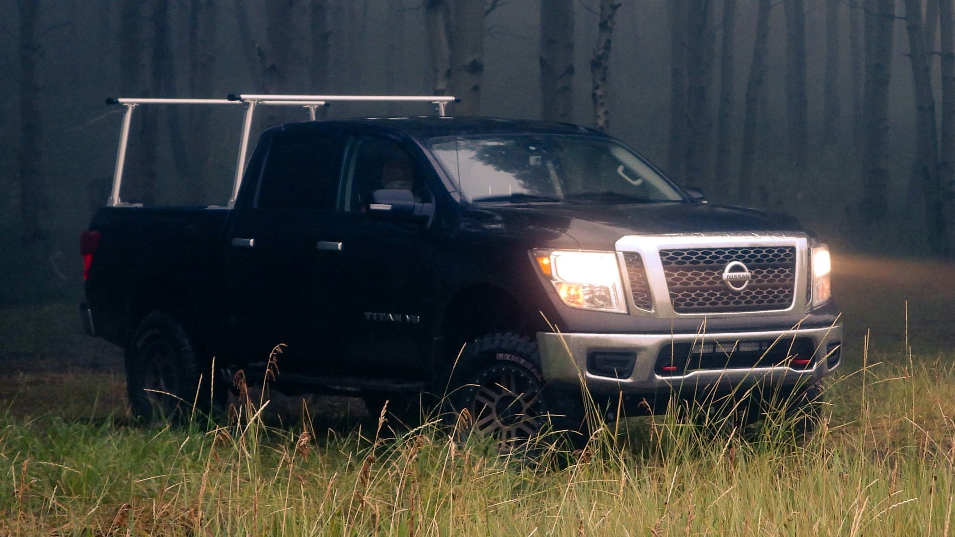 A truck parked in the middle of a forest