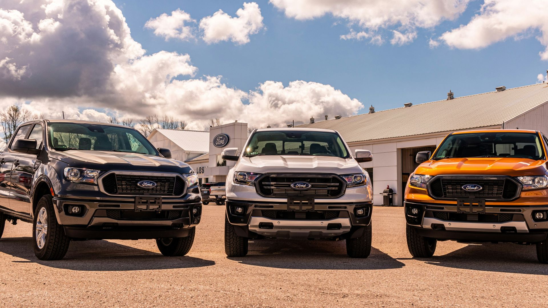 green and yellow chevrolet car on brown sand under blue and white sunny cloudy sky during