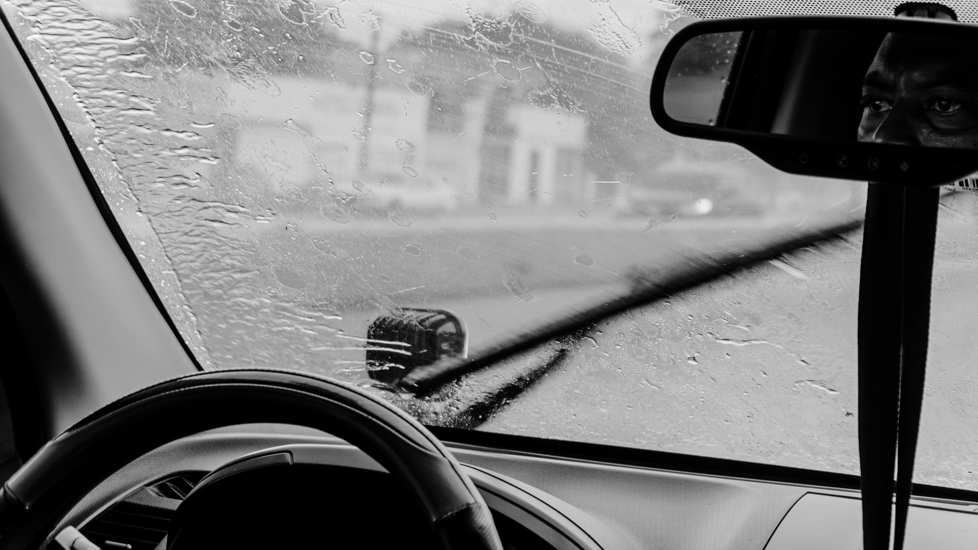 Windshield wipers clearing rain from a car window