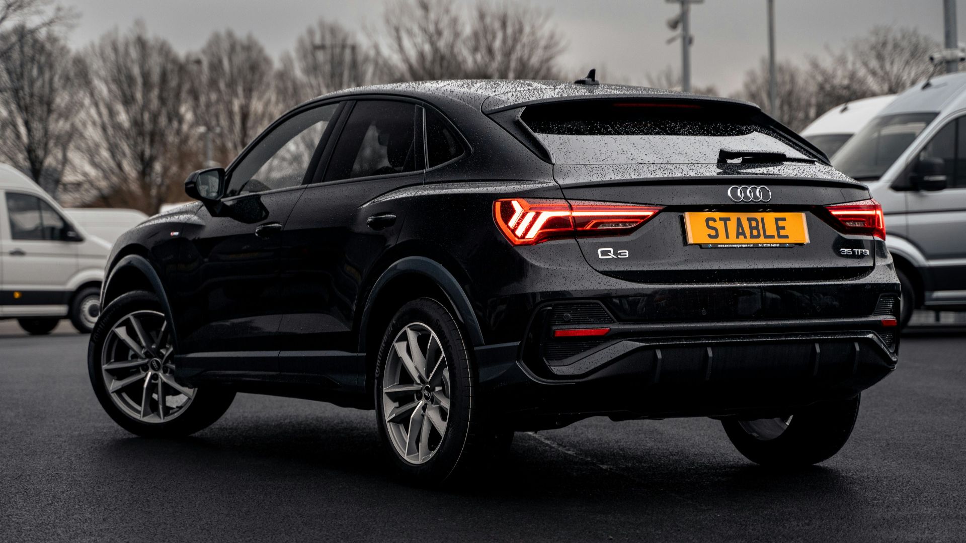 a black car parked in a parking lot