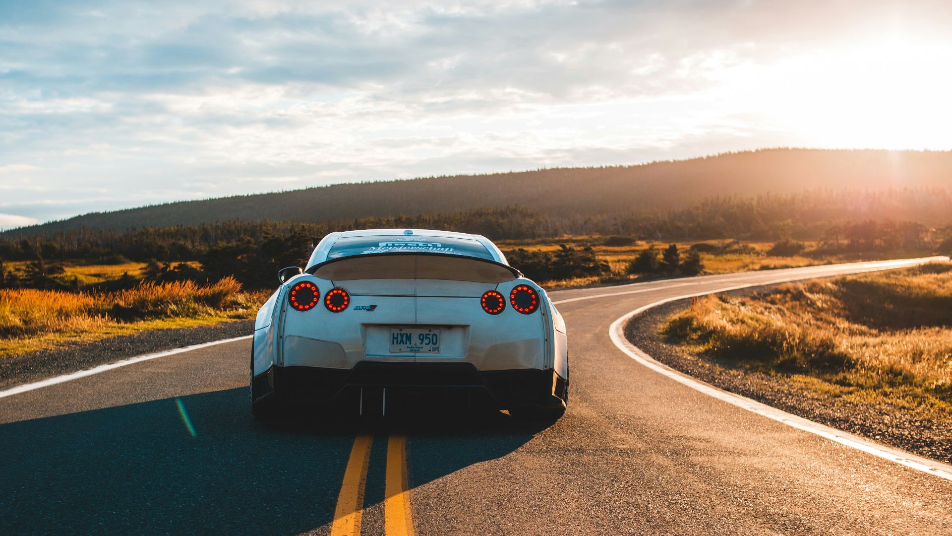 silver sports coupe on asphalt road