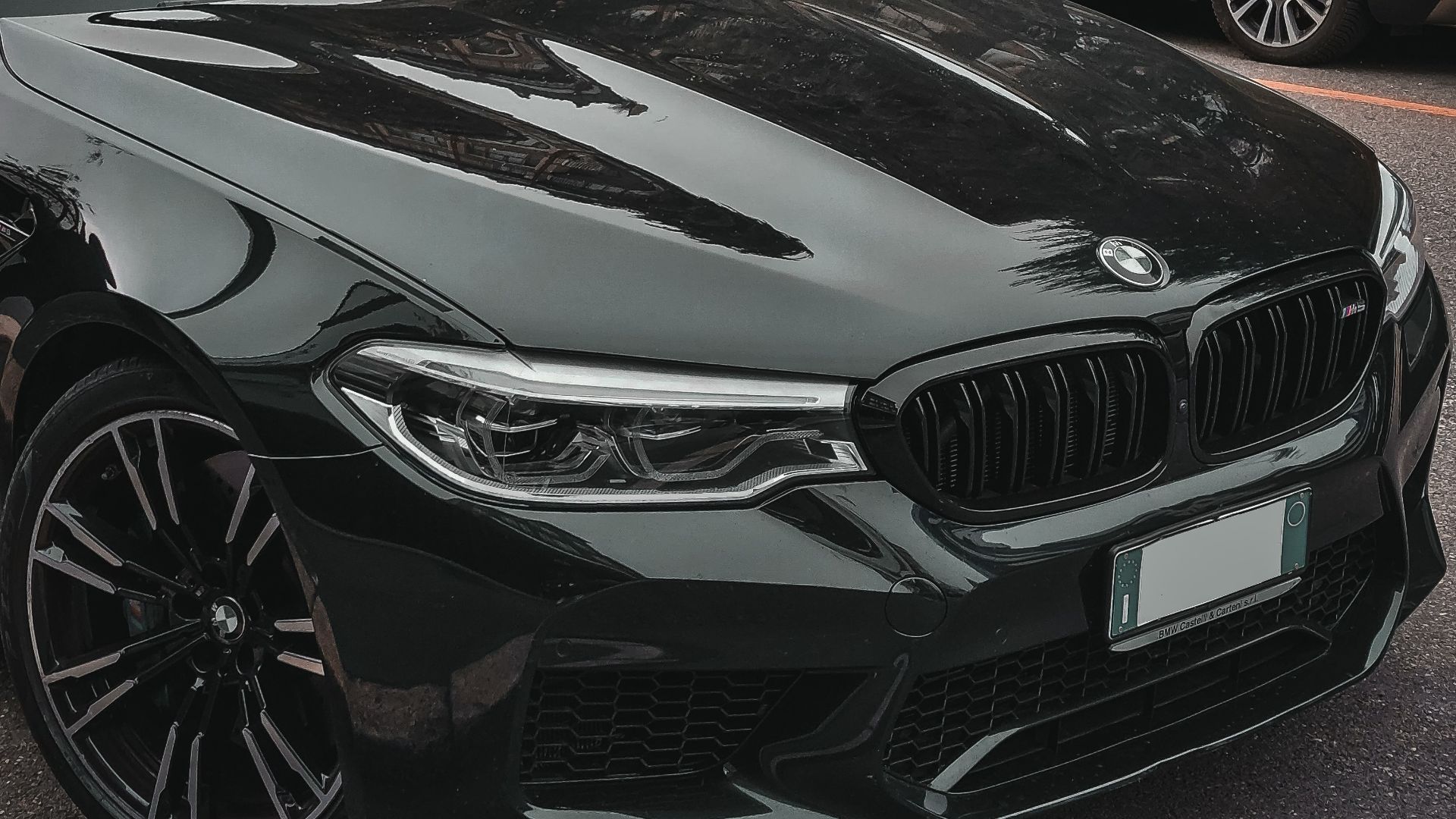 a black car parked next to another car