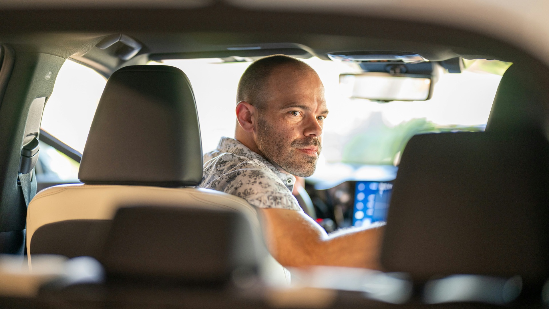 a man sitting in the passenger seat of a car